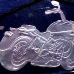 Etched motorcyle in glass with a two-stage sandcarving technique.