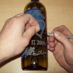 Removing and cleaning the stencil off the wine bottle