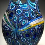 A blue murrine cane blown glass art with elegant designs.